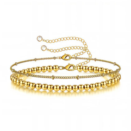 Layered gold bracelet set with polished beads and fine adjustable chains