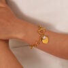 Gold chain bracelet with toggle clasp and pavé crystal heart charm