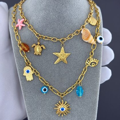 Gold charm necklace with starfish, turtle, shells and pink starfish accents Pendant Size: 2 x 2 cm.