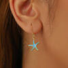 Gold hook earrings with turquoise enamel starfish charms