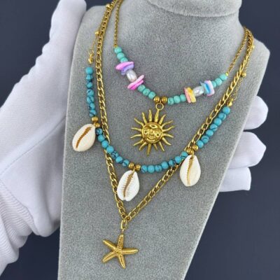Layered gold necklace with turquoise beads, shells, and gold starfish pendant