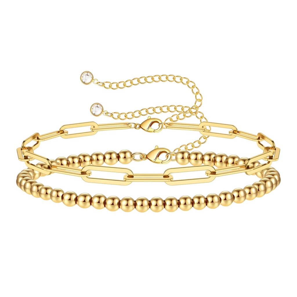 Layered gold bracelet set with modern paperclip chain and polished bead design.