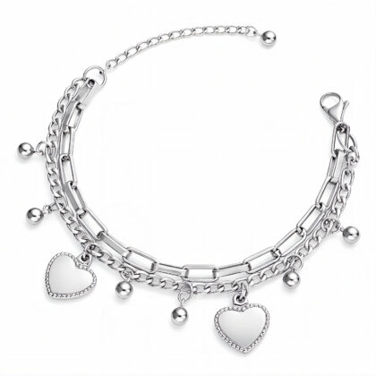Silver layered chain bracelet with heart charms on white background