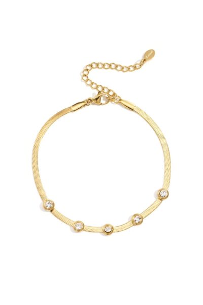 Gold herringbone bracelet with small bezel-set crystals and adjustable clasp on white background