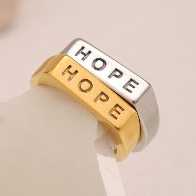 Engraved HOPE statement design 18K gold PVD coating Premium stainless steel Water & sweat resistant Minimal signet-style shape Ideal for stacking & layering Unisex design