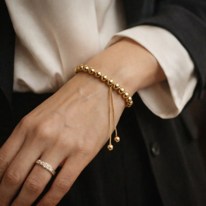 Gold stainless steel bead bracelet with 10 mm round beads and adjustable extender