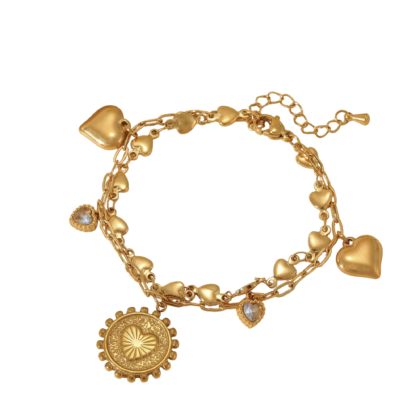 Gold heart charm bracelet with zircon detail and layered chains on white background