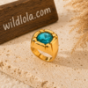 18K Gold Plated Geometric Statement Ring, Waterproof Non-Tarnish Stainless Steel with Blue Glass Inlay (US Size 7 / EU 54) Gold statement ring with a turquoise gemstone displayed in a boho beach setting with a wooden Wild Lola sign