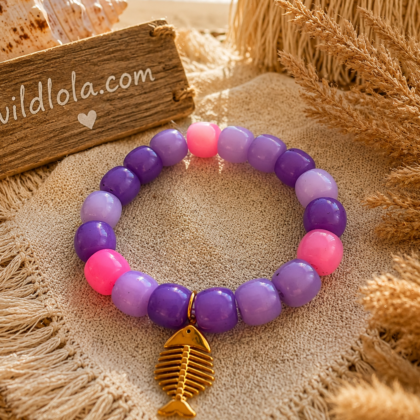 π Wild Lola Fishbone Bracelet Lavender Beach Handmade colorful acrylic bead bracelet with a gold fishbone charm displayed on a boho beach-inspired background.