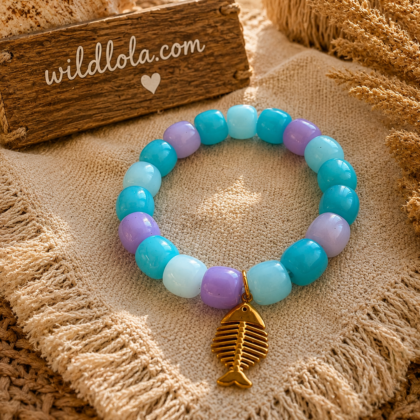 π Wild Lola Fishbone Bracelet Lavender Beach Handmade colorful acrylic bead bracelet with a gold fishbone charm displayed on a boho beach-inspired background.
