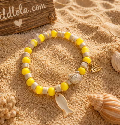 Wild Lola Sunshine Turtle Bracelet Yellow acrylic bead bracelet with beach-inspired charm and turtle detail displayed on sandy beach background with Wild Lola sign.
