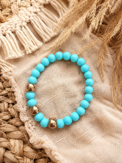 beads3 Soft blue elastic bracelet with acrylic beads and gold accents styled on a neutral boho background