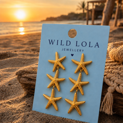 Gold stainless steel starfish earrings featuring three dangling starfish charms