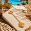 Gold Seashell Bikini Charm Gold stainless steel bikini charm with a seashell pendant and clip attachment.