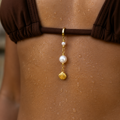 Pearl Shell Bikini Charm Gold Gold bikini charm with pearl accents and shell pendant attached to a brown bikini top.