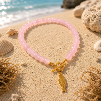 Colorful beaded necklace with three gold-tone koi fish charms and toggle clasp.