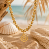 Golden Spiral Necklace Gold stainless steel necklace with polished bead chain and spiral pendant charm.