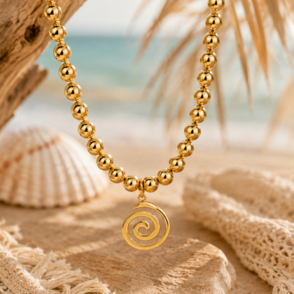 Gold stainless steel necklace with polished bead chain and spiral pendant charm.
