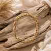 Gold Link Chain Necklace – Stainless Steel Gold stainless steel link chain necklace displayed on driftwood in a boho beach setting.